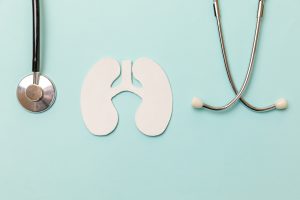 Picture of a stethoscope and a paper cutout of lungs.