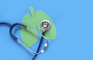 Picture of a stethoscope and a paper diagram of lungs.